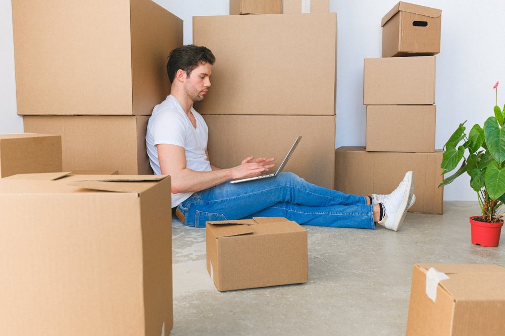 remote worker leaning on a cardboard box