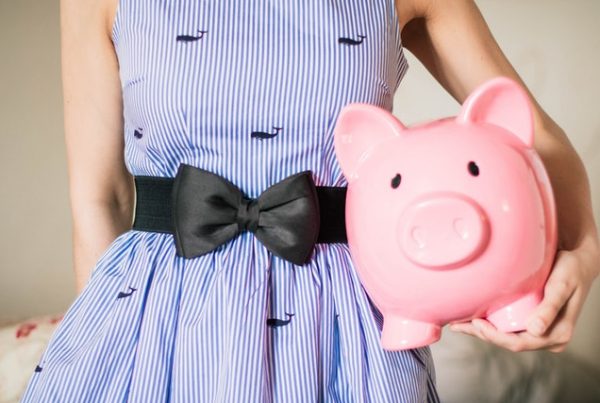 Woman holding a piggy bank.