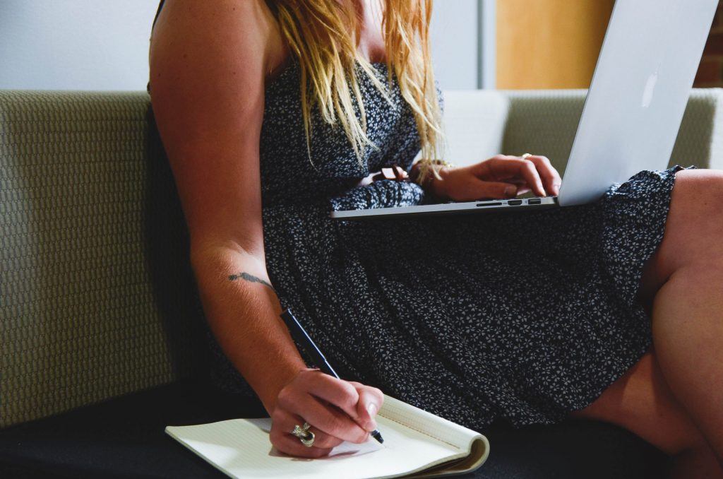 A person making notes on how niche expertise can elevate your freelance writing career