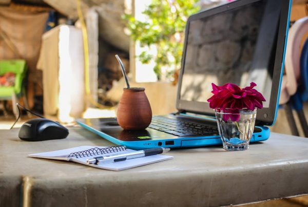 A laptop sitting on a table in a coworking space.