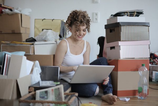 woman reading freelancer’s guide to managing clients and deadlines while sitting among boxes